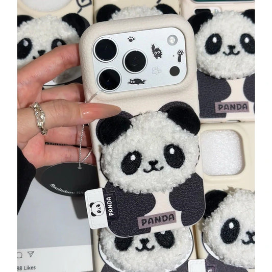 Phone case with panda design held by a hand, with more phone cases featuring pandas in the background.