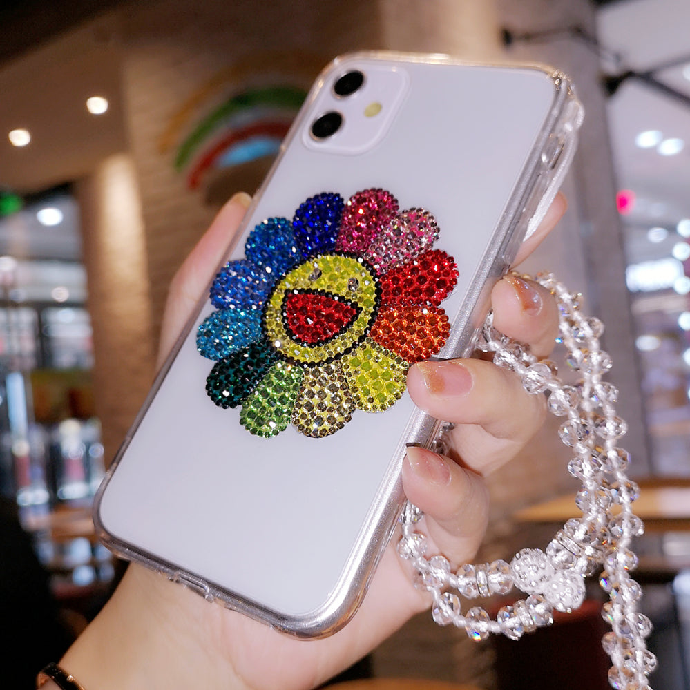 Coque iPhone faite à la main, luxueuse et scintillante, ornée de diamants et de tournesols colorés.