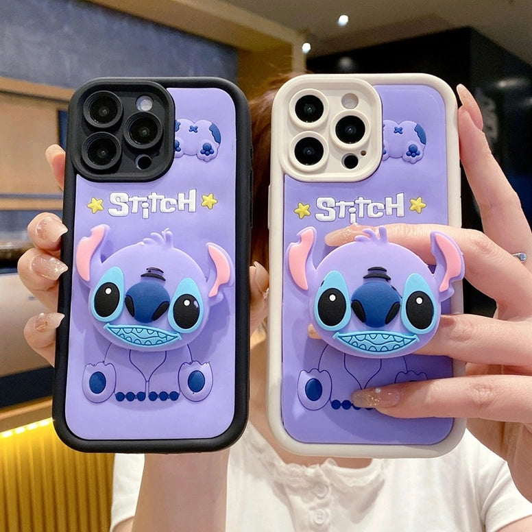 Two phone cases with a cartoon character design held by a person.