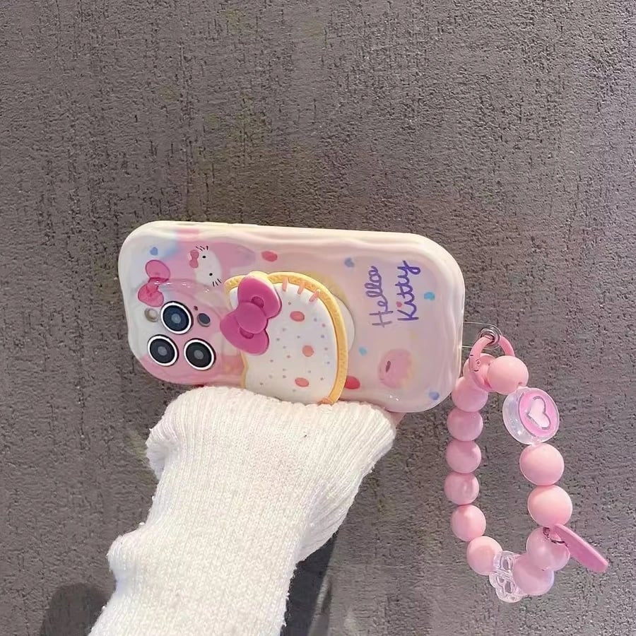 Hello Kitty phone case with a pink strap on a gray background