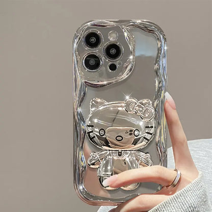 Silver phone case with a cat design held by a hand against a neutral background