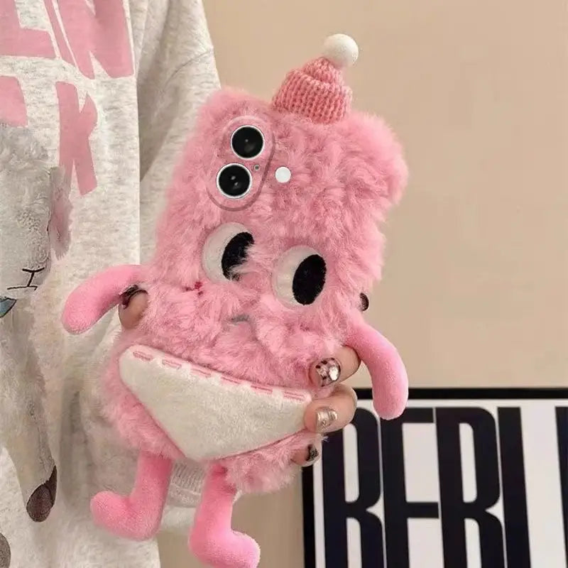 Pink plush phone case with googly eyes and a knit hat held by a person.