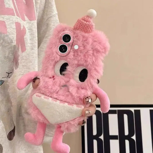 Pink plush phone case with googly eyes and a knit hat held by a person.