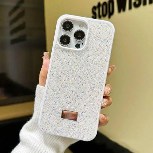 Phone case with glittery texture held by a person wearing a white sweater.