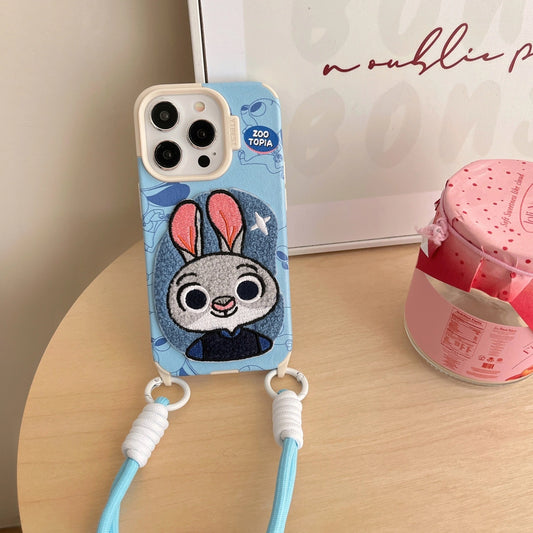 Phone case with cartoon character and strap on a wooden surface