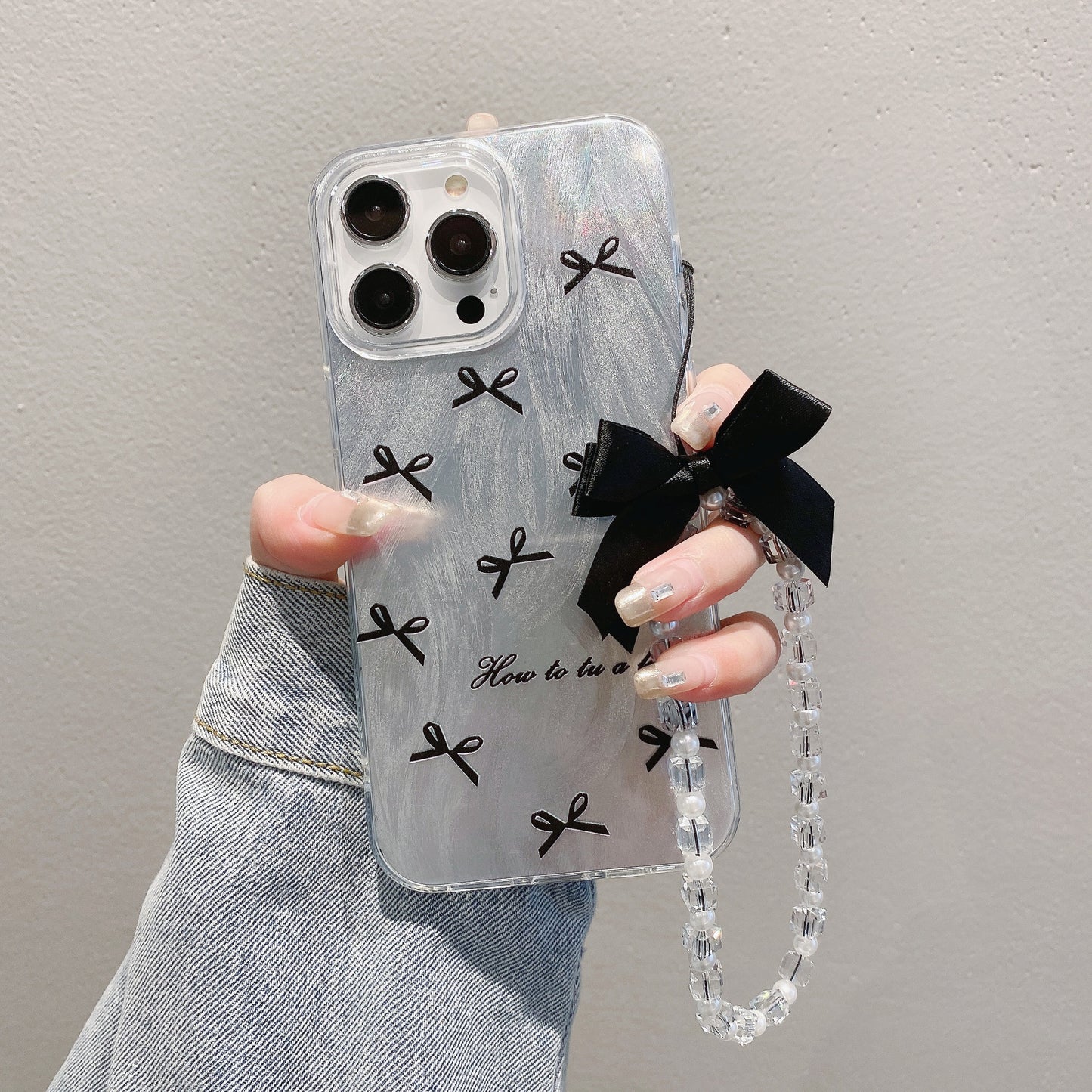 Coque de téléphone IMD avec joli nœud et bracelet pour iPhone 17, 16, 15, 14, 13, 12, 11 Pro Max, X, XR, 7 et 8