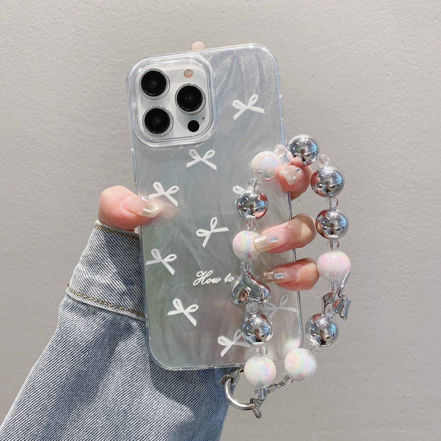 Coque de téléphone IMD avec joli nœud et bracelet pour iPhone 17, 16, 15, 14, 13, 12, 11 Pro Max, X, XR, 7 et 8