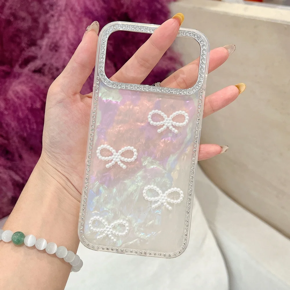 S0ed5f1c1cd8347b1b7b44780566b08a6A.webp Luxury 3D Pearl Bow Bling Diamond Inlaid Phone Case For iPhone 17 17 Air 17 Pro Max Girly Aurora Laser Acrylic Shockproof Cover