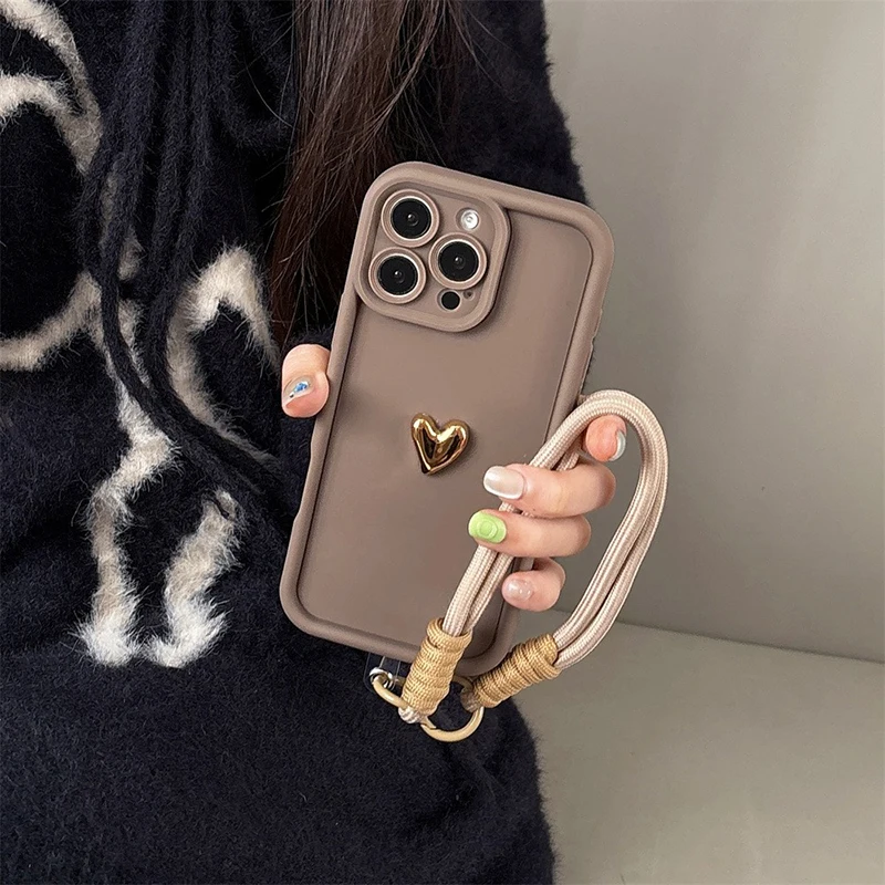 S3855f82247d94cf1b2c5681cbe635154g.webp Cute Korean 3D Golden Love Heart Soft Case For iPhone 16 17 Pro Max 15 14 13 12 11 Pro 16E 7 8 Plus Wrist Chain Hang Strap Cover