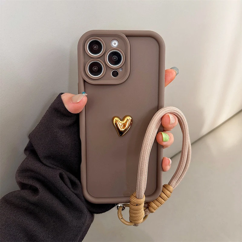 Sce2fa05ac2ab48fe91406d1fde547230C.webp Cute Korean 3D Golden Love Heart Soft Case For iPhone 16 17 Pro Max 15 14 13 12 11 Pro 16E 7 8 Plus Wrist Chain Hang Strap Cover