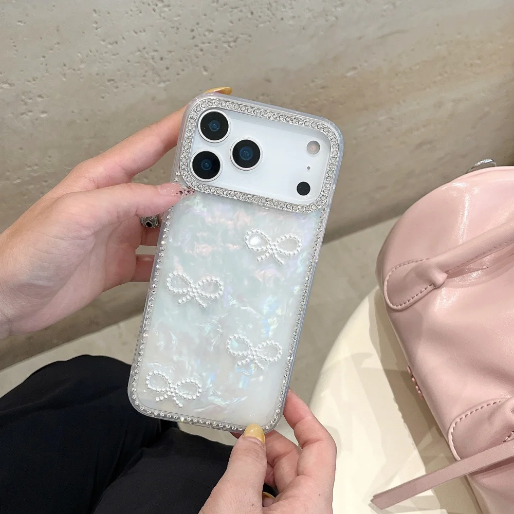 Sf107068a1834432a861d9d855384651eY-1.webp Luxury 3D Pearl Bow Bling Diamond Inlaid Phone Case For iPhone 17 17 Air 17 Pro Max Girly Aurora Laser Acrylic Shockproof Cover